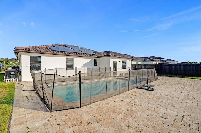 view of pool featuring a fenced backyard, a fenced in pool, and a patio area