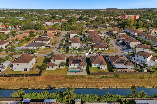 birds eye view of property with a residential view and a water view