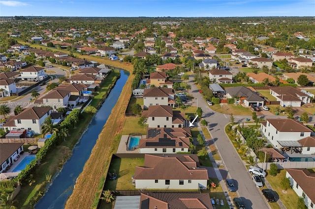 drone / aerial view with a residential view and a water view