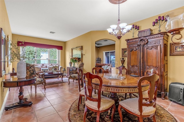 dining room with light tile patterned flooring and an inviting chandelier