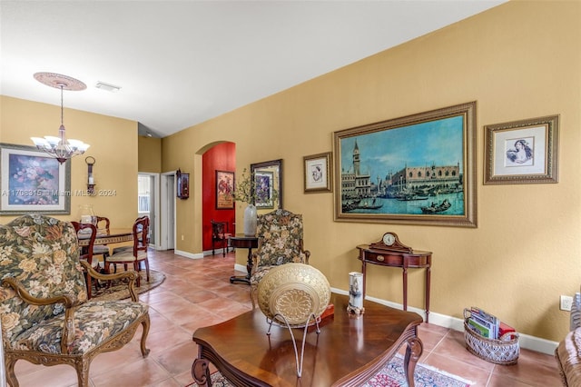 sitting room with tile patterned flooring and a notable chandelier