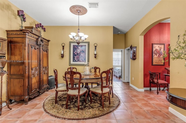 tiled dining area with a notable chandelier