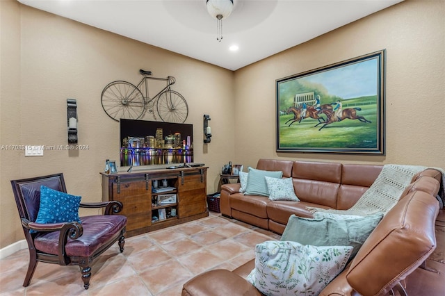 tiled living room with ceiling fan