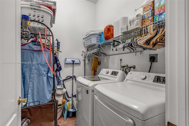 laundry room with washer and clothes dryer and tile patterned flooring