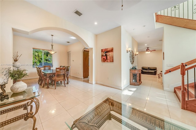 2913 SW 13th St, Miami, FL 33145 - dining room featuring arched walkways, ceiling fan, tile patterned floors, baseboards, and stairs