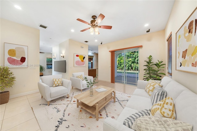 tiled living room featuring ceiling fan