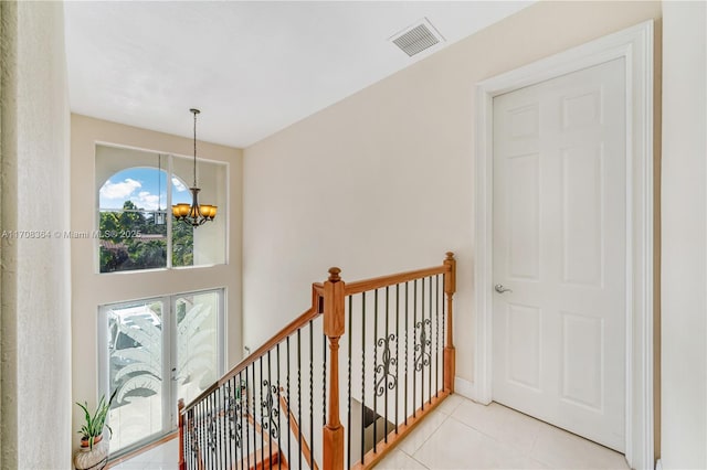 2913 SW 13th St, Miami, FL 33145 - corridor with a chandelier, tile patterned flooring, and an upstairs landing