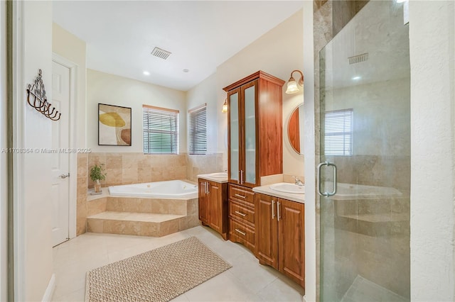 bathroom with plus walk in shower, vanity, and tile patterned floors