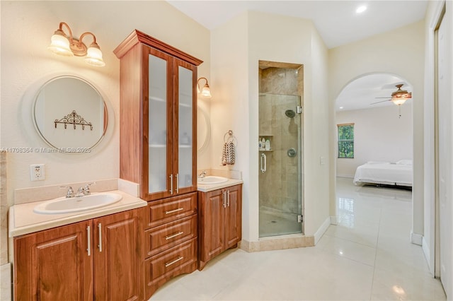 bathroom with tile patterned flooring, vanity, a shower with door, and ceiling fan