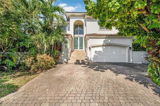 2913 SW 13th St, Miami, FL 33145 - mediterranean / spanish home with stucco siding, decorative driveway, a tile roof, and a garage