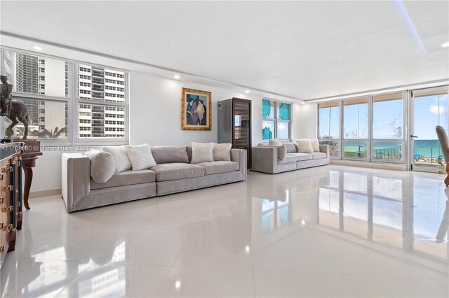 living room with a water view and light tile patterned floors