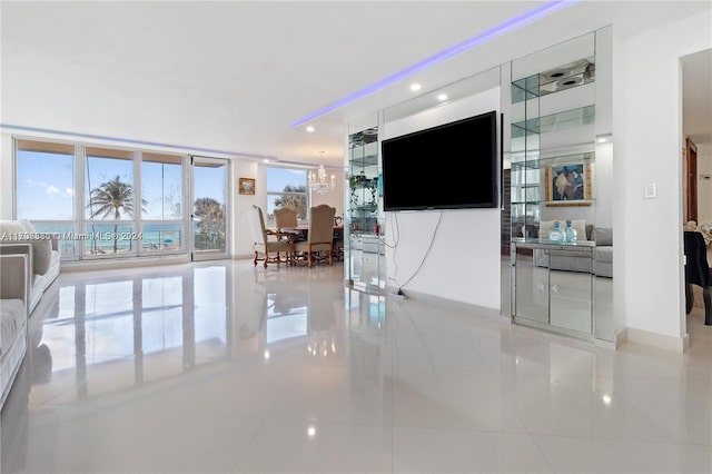 living room with floor to ceiling windows and light tile patterned flooring