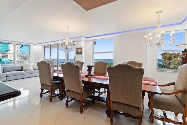 tiled dining room featuring a notable chandelier and plenty of natural light