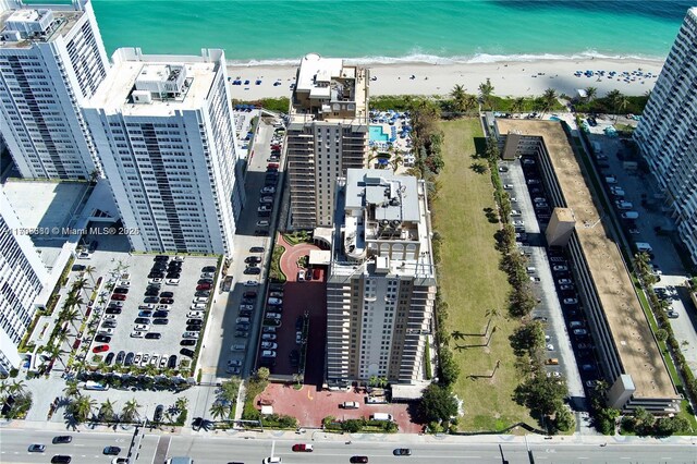 drone / aerial view with a water view and a view of the beach