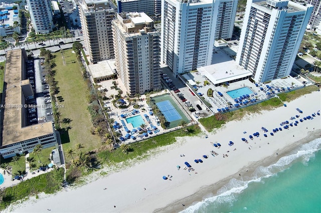 birds eye view of property featuring a water view and a view of the beach