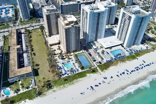 bird's eye view with a water view and a view of the beach