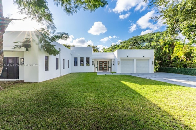 1120 Wallace St, Coral Gables, FL 33134 - view of front facade featuring stucco siding, french doors, concrete driveway, and an attached garage