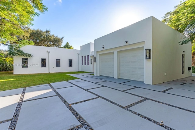 exterior space with a front yard and stucco siding