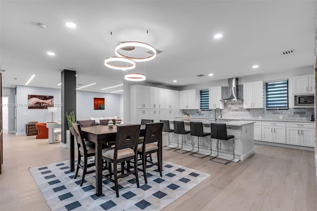 dining room featuring sink and light wood-type flooring