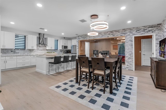 dining area featuring light wood-style flooring, visible vents, and recessed lighting