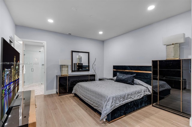 bedroom with baseboards, wood finished floors, and recessed lighting