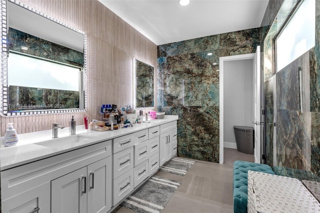 bathroom with vanity and tile walls