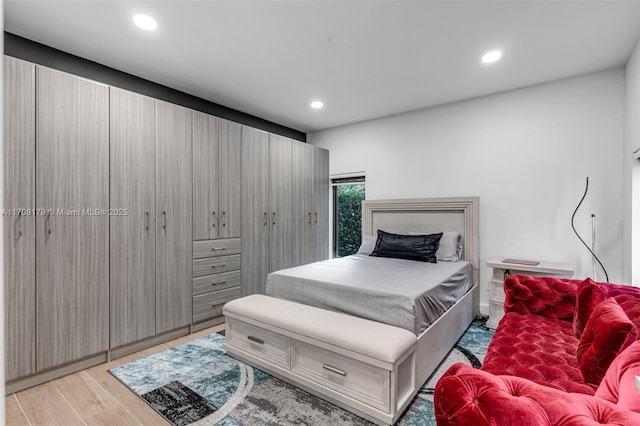 bedroom with light wood-type flooring and recessed lighting