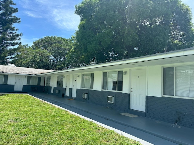 view of side of property with a porch and a lawn