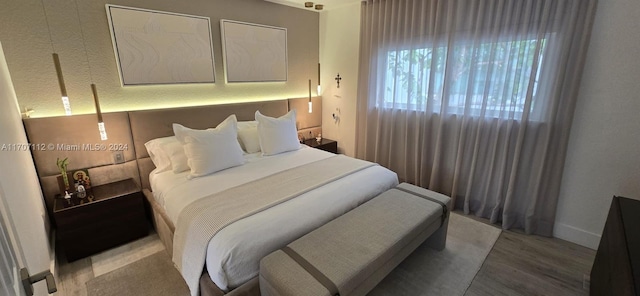 bedroom with wood-type flooring