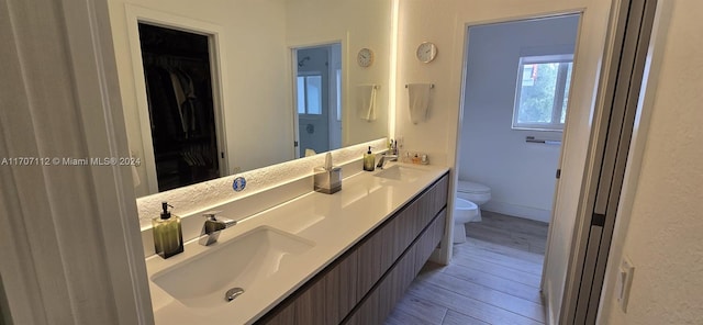 bathroom featuring hardwood / wood-style flooring, vanity, toilet, and a bidet