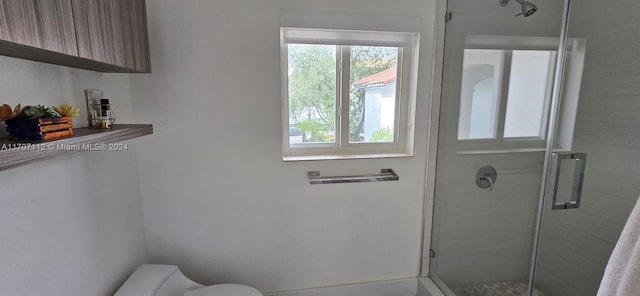 bathroom featuring walk in shower and toilet