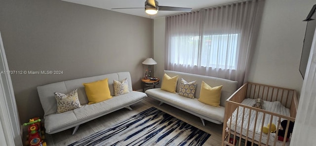 living room featuring hardwood / wood-style flooring and ceiling fan