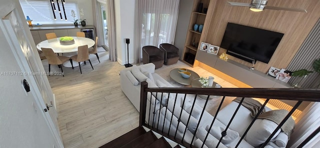 living room with light hardwood / wood-style floors, an inviting chandelier, and beverage cooler