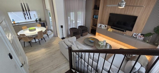 living room featuring light wood-type flooring, plenty of natural light, and ceiling fan