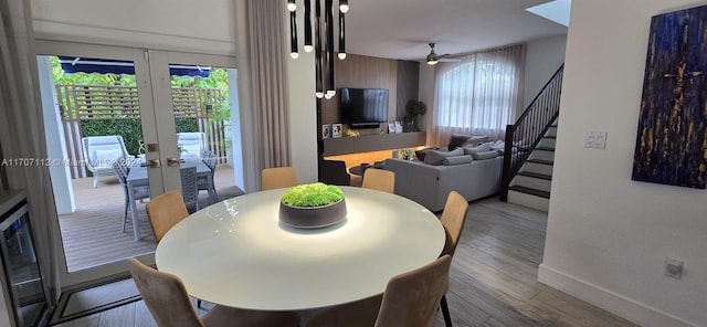 dining area with french doors, ceiling fan, and hardwood / wood-style floors