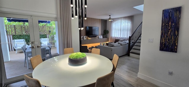 dining area with ceiling fan, light hardwood / wood-style floors, and french doors