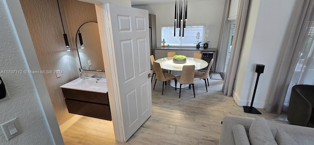 interior space featuring vanity, wood-type flooring, and beverage cooler