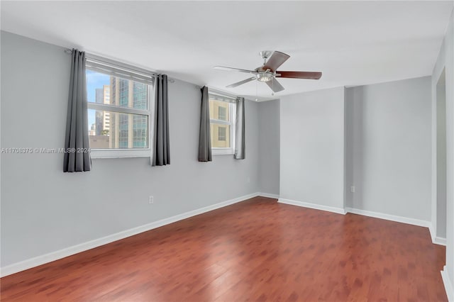 unfurnished room featuring ceiling fan and dark hardwood / wood-style flooring