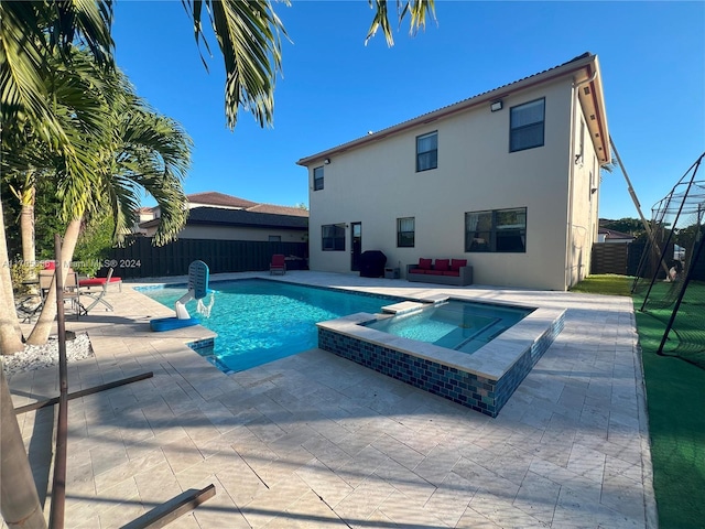 view of swimming pool featuring an in ground hot tub and a patio area