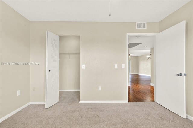 bedroom featuring ceiling fan, a closet, and light carpet