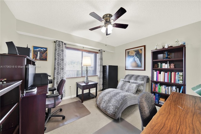 office with ceiling fan, light colored carpet, and a textured ceiling