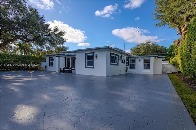 rear view of property featuring a patio area