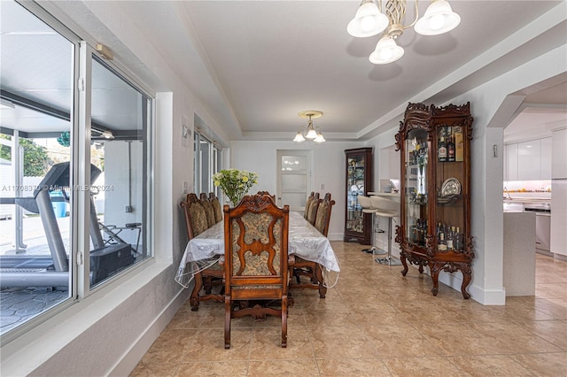 dining room featuring light tile patterned floors and an inviting chandelier