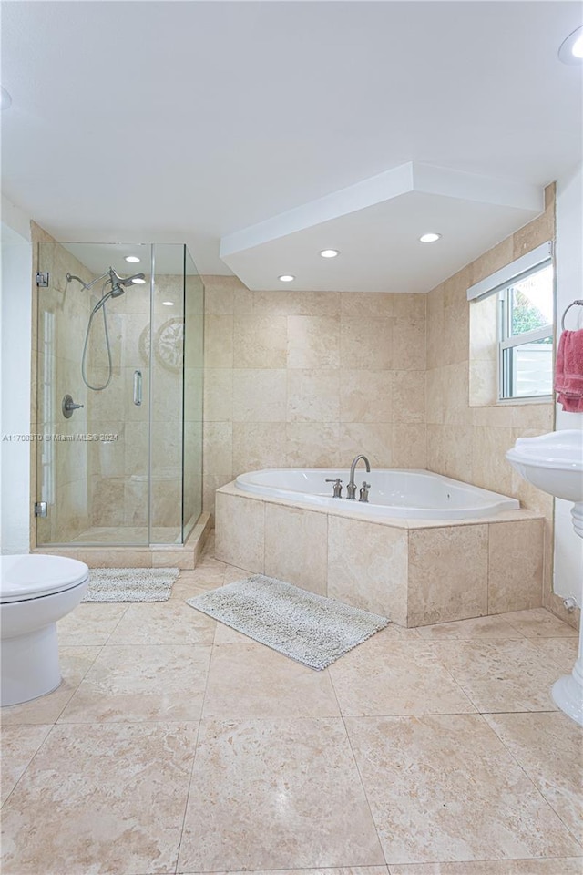 bathroom with tile patterned floors, separate shower and tub, and toilet