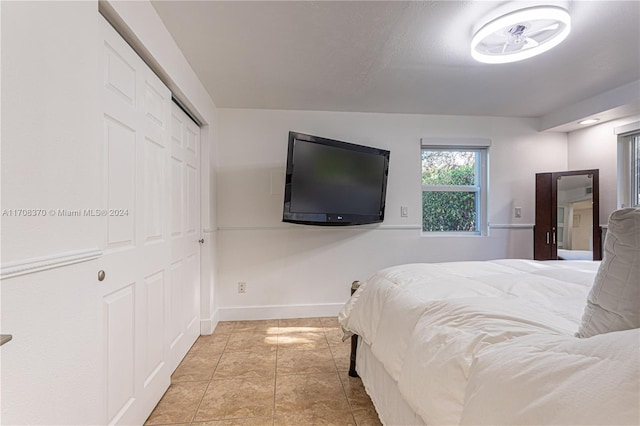 tiled bedroom featuring a closet