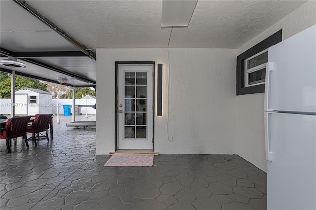 view of patio / terrace featuring a storage unit