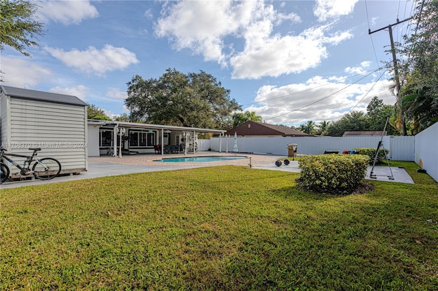 view of yard featuring a fenced in pool and a patio area