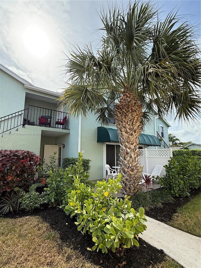 view of side of property with a balcony