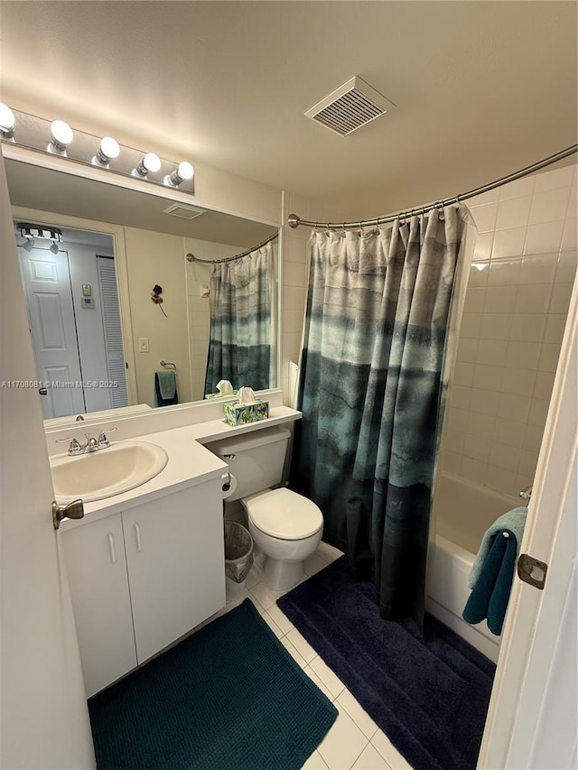 full bathroom featuring tile patterned floors, shower / tub combo with curtain, vanity, and toilet