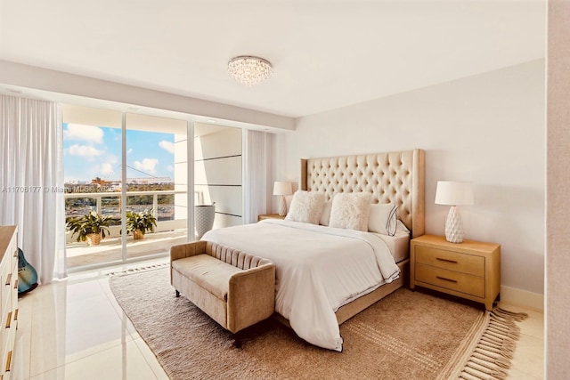 tiled bedroom with a wall of windows and baseboards